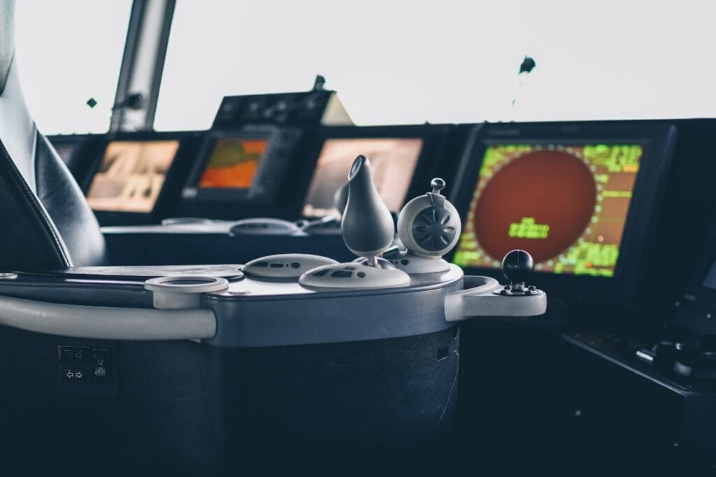 pexels-photo-3582597 Close-up view of ship navigation controls and radar screens, capturing maritime technology.